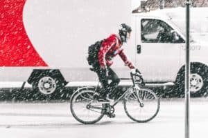 snowing-cyclist-cycling-road